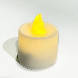 Macro view of warm LED candle with realistic flame on white cylinder casing