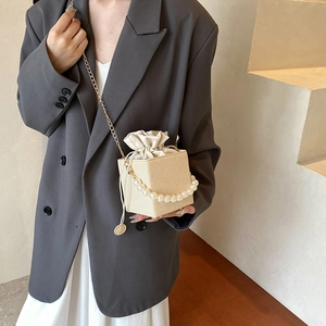 Elegant beige straw mini crossbody bag with pearl handle and chain strap for summer