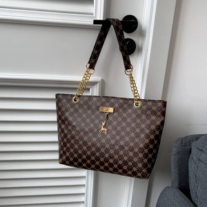 Dark brown tote bag with vintage monogram pattern and golden deer charm detail
