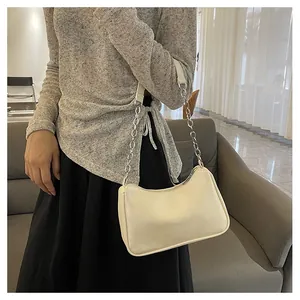 Chic cream-colored hobo bag featuring a silver metal chain shoulder strap detail