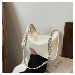 Detailed view of cream hobo bag with silver chain strap and smooth leather texture
