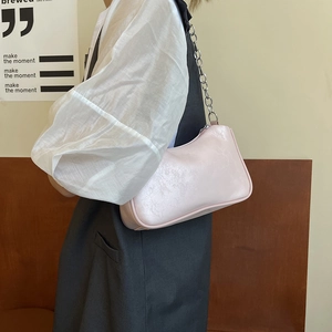 Pink PU leather underarm bag with silver chain strap shown at a 45-degree angle