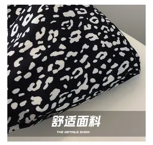 Detail shot of black and white leopard print fabric showing durable twill texture and stitching