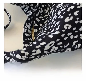 Detailed close-up of the black and white leopard print canvas tote bag shoulder strap