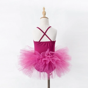 Detail of cross-back straps and layered tulle tutu on a pink ballet leotard for girls