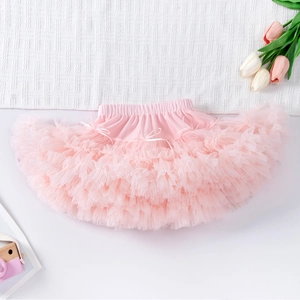 Detail of multi-layer pale pink tutu skirt with elastic waist and ribbon bow ornament