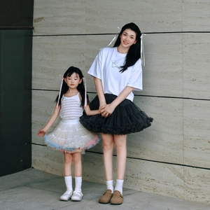 Detailed outdoor view of mother and daughter in layered tulle tutu skirts and casual tops