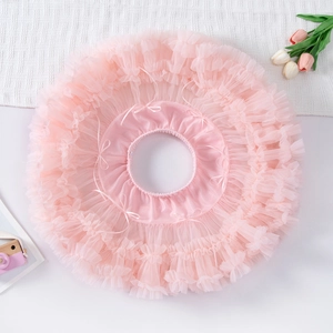 Detailed flat lay of pink tulle tutu skirt with satin bow and layered mesh texture