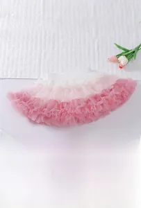 Detail view of pink and white gradient tulle layers on an elastic tutu skirt for girls