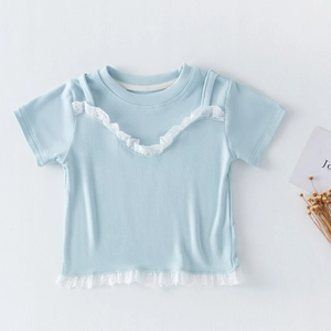 Détail du haut bleu clair pour fille avec bordure en dentelle blanche et texture côtelée douce