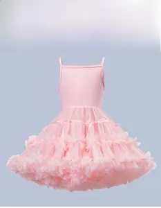 Close-up of pink tutu dress featuring layered mesh fabric and silk bow accents
