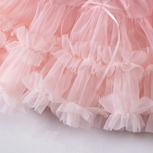 Detailed macro view of pink tiered tulle layers and a decorative satin ribbon bow