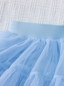 Close-up of high-elastic waist band and multi-layer blue mesh tulle on girls tutu skirt