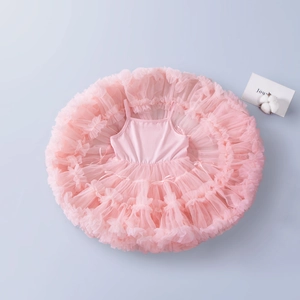 Detail of multi-layered pink tutu dress featuring soft mesh tulle and thin straps
