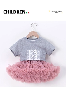 Detail of grey short sleeve knit top with white lace patch and pink layered mesh tutu skirt