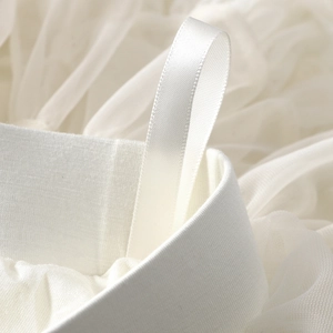 Detail of wide elastic waistband and satin loop on white layered tulle tutu skirt