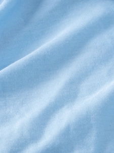 Close-up of light blue knitted mesh fabric texture on a girls tutu princess dress