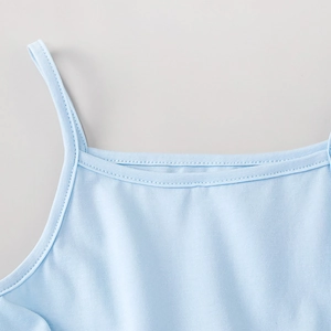 Detail of light blue tutu dress with thin shoulder straps and fine stitching