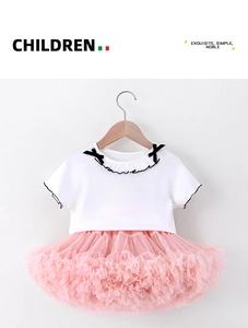 Detailed view of white knit top with lace trim and pink layered tulle tutu skirt