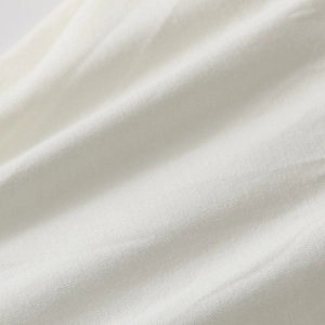 Detailed macro view of white layered tulle fabric texture with a soft aesthetic