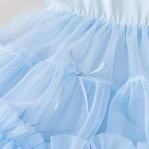 Close-up of light blue tutu dress featuring layered mesh frills and a satin bow detail