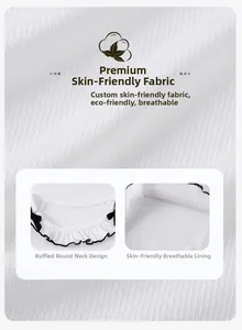 Detail of white ribbed knit fabric with ruffled collar and black bow accents for girls