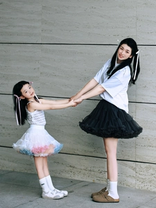 Women and girls in layered mesh tutu skirts standing together for family fashion look
