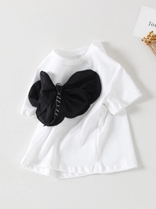 T-shirt bianca in cotone per bambine con grande fiocco in tessuto nero e strass argento