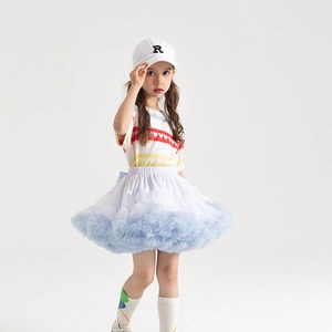 Detail of girls' rainbow striped T-shirt with heart print and white layered tutu skirt