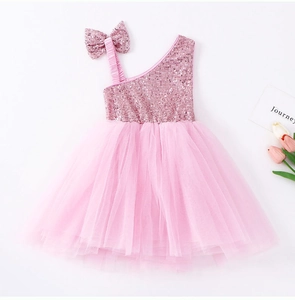 Detailed view of pink sequined bodice and large shoulder bow on girls' tutu dress
