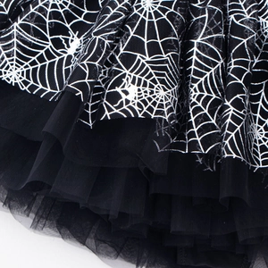 Detail showing layers of black tulle fabric with white spider web print for girl's tutu