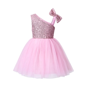 Detail of pink sequins, shoulder bow, and tiered tulle layers on a girl's party dress