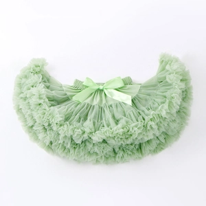Detail of multi-layered light green tutu skirt with satin bow and elastic waist