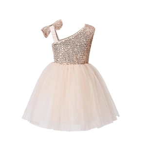 Detail of champagne sequined bodice and mesh tutu on girl's one-shoulder formal dress