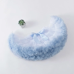 Flat lay of light blue multi-layer mesh tutu skirt with a silk bow for girls