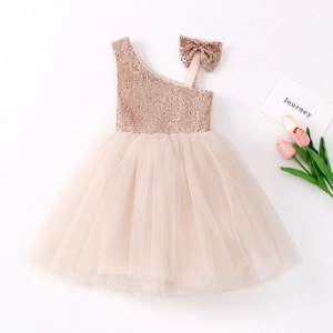 Detail of sequins on champagne girl princess dress with matching bow headband