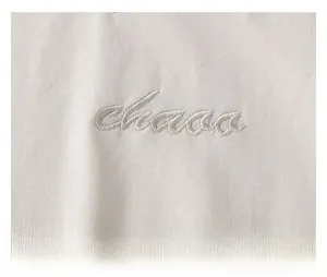 Close-up of premium letter embroidery detail on girl's cotton T-shirt fabric