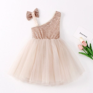 Champagne sequin bodice and bow detailing on a tiered tulle flower girl dress