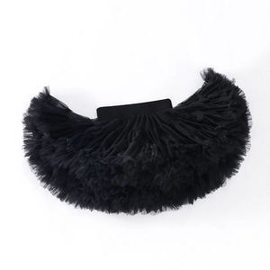 Detailed view of layered black tulle tutu skirt showing volume and elastic waistband