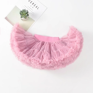 Detailed top view of pink layered tulle tutu skirt with elastic waistband on white surface