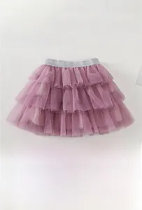 Detailed view of tiered tulle tutu skirt with white polka dots and silver elastic waistband