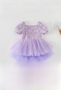 Detailed view of girl's purple ballet leotard with floral prints and multilayer mesh tutu