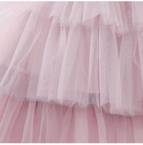 Detail of pink multi-layered tulle mesh ruffles on a girl princess cake dress