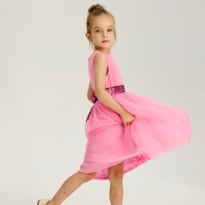 Detail of pink girls party dress showing multi-layered tulle skirt and purple sequin belt