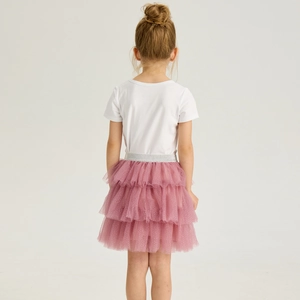 Detail of girls' tiered pink tutu skirt with silver glitter waistband and white tee