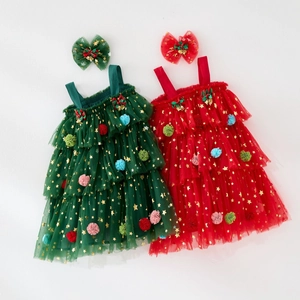 Detail of Christmas tutu dress with gold stars, pom-poms, and festive plaid bows