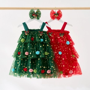 Close-up of girls' Christmas tutu dress with gold stars, pom-poms and bell bow details