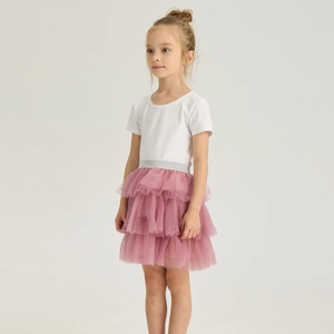 Detail of pink tiered tulle skirt for girls with silver glitter waistband and white t-shirt