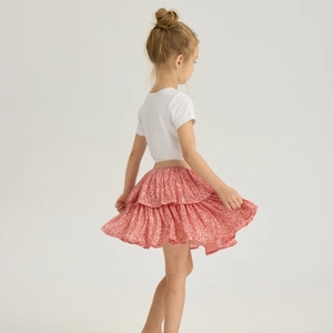 Detail of girls pink sequin tiered tutu skirt showing the flowing layers and gold waistband