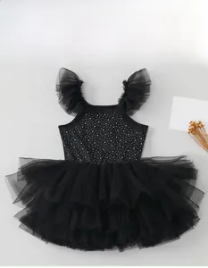 Detailed view of black girls' ballet tutu dress with sparkling sequins and ruffle sleeves